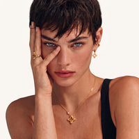 Model wearing Blooming Star gold open four-petal pendant necklace with delicate adjustable chain | Olaty