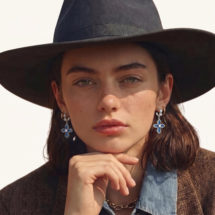 Model wearing blue denim cross drop earrings with silver-tone hoops and zirconia details | Olaty