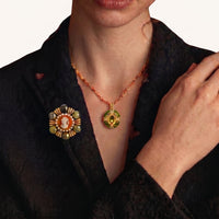 Empress Cameo Brooch worn on a black blazer featuring portrait cameo, green natural stones and gold-tone details | Olaty