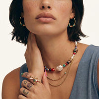 Gold botanical statement ring with colorful natural stones and freshwater pearls styled on hand | Olaty