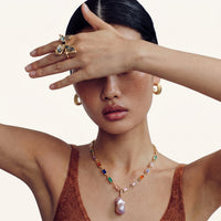 Butterfly statement ring worn on hand with iridescent shell wings and adjustable gold-tone band | Olaty