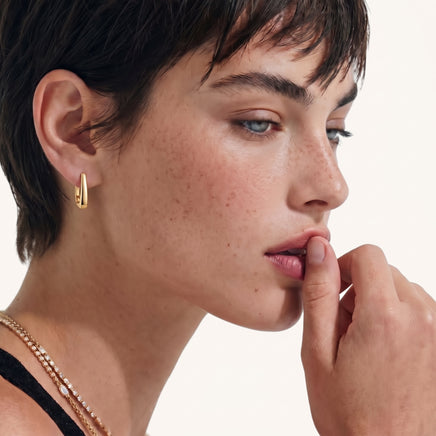 Model wearing Golden Hour Sculpted Huggie Earring in polished gold-plated sterling silver close-up | Olaty