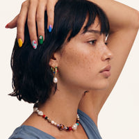 Baroque gem pearl hoop earrings worn with colorful jewelry styling | Olaty