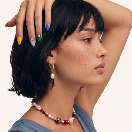 Baroque gem pearl hoop earrings worn with colorful jewelry styling | Olaty