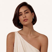  Model wearing Starlit pavé huggie hoop earrings | Olaty