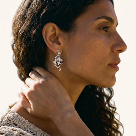 Mystic serpent statement drop earring worn on ear with sculptural flowing form and marbled centerpiece | Olaty