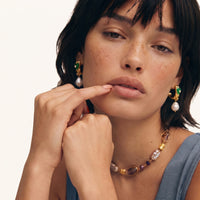 Emerald green heart pearl drop earrings worn with sculptural gold hoops and freshwater pearls | Olaty