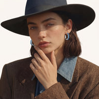 Model styling blue denim hoop earrings with a brown blazer and denim shirt | Olaty