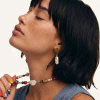 Amber baroque pearl drop earring worn with rectangular amber-tone stone and elongated pearl pendant | Olaty