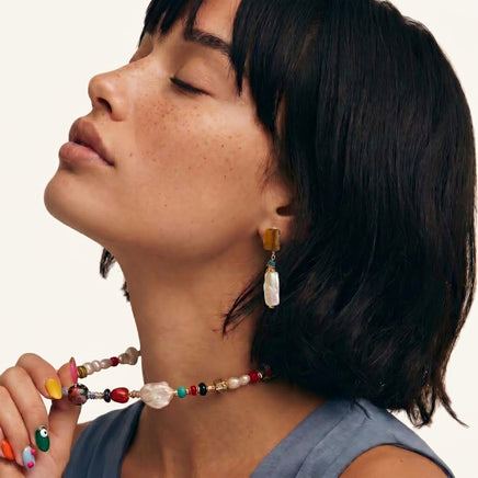 Amber baroque pearl drop earring worn with rectangular amber-tone stone and elongated pearl pendant | Olaty