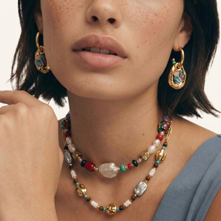 Model wearing Shell Mosaic convertible hoop earrings with iridescent shell drop pendants | Olaty