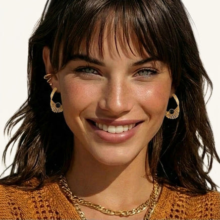 Sculptural gold mesh earrings with black resin center accents worn for a bold statement look | Olaty