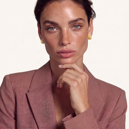 Model wearing round Celestial Dome gold stud earrings with subtle celestial detailing | Olaty