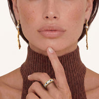 Long sculptural gold-tone pearl drop earrings with fluid molten texture worn on model | Olaty