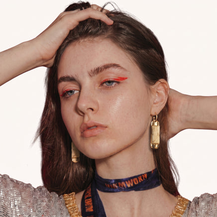 Cream marbled resin column drop earrings with polished gold-tone details worn on model | Olaty