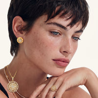 Model wearing Celestial Dome star stud earrings styled with coordinating gold celestial jewelry | Olaty