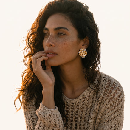 Two-tone rose statement stud earring worn on ear featuring textured gold petals and silver-tone wraps | Olaty