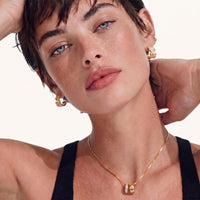 Stardust Scatter Hoop Earrings styled on model, highlighting their curved statement silhouette and scattered cubic zirconia sparkle | Olaty