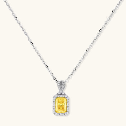 Yellow emerald cut moissanite pendant necklace with diamond halo in white gold | Olaty