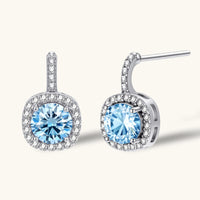 GRA certified blue moissanite diamond celestial halo drop earrings in 925 sterling silver front and angled view | Olaty