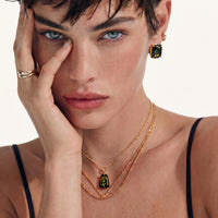 Forest Gold Amber Necklace worn with layered gold chains, featuring a deep green amber pendant in 18K gold-plated 925 sterling silver | Olaty