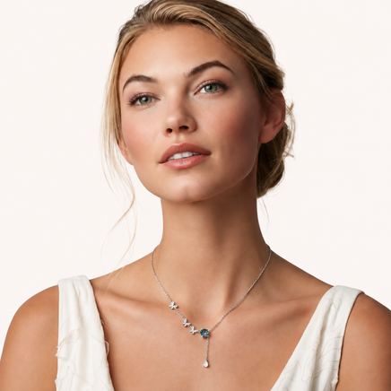 Rainbow moissanite butterfly necklace worn with delicate sterling silver chain and teardrop detail | Olaty