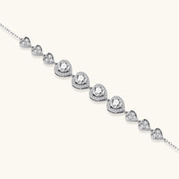 Sterling silver hearts moissanite bracelet featuring four round center stones and pavé heart details | Olaty