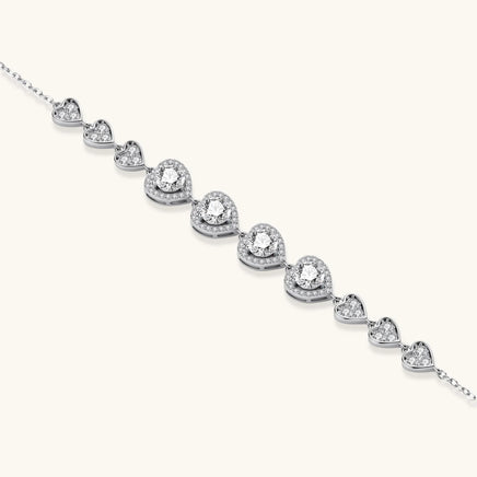 Sterling silver hearts moissanite bracelet featuring four round center stones and pavé heart details | Olaty