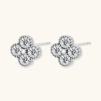 GRA certified moissanite diamond quatrefoil stud earrings in polished 925 sterling silver, angled side view | Olaty
