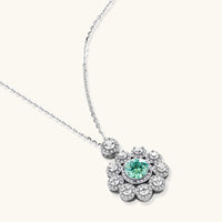 Angled view of Green Moissanite Diamond Daisy Bloom Necklace showing round green center stone and brilliant floral setting | Olaty