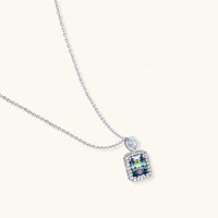 Angled view of Prism Dreams Necklace showing prismatic rectangular moissanite, pavé halo and delicate sterling silver chain | Olaty