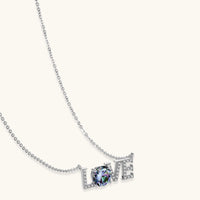 Rainbow moissanite LOVE pendant necklace in polished sterling silver angled product view | Olaty