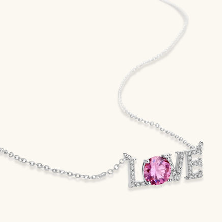 Pink moissanite LOVE pendant necklace in polished 925 sterling silver close-up angled view | Olaty