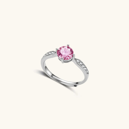 Angled view of Pink Dreams Ring showing round pink moissanite and polished adjustable sterling silver band | Olaty
