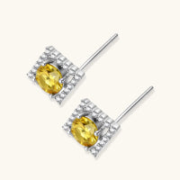 Angled back view of Yellow Moissanite Golden Halo Stud Earrings showing round center stones and sterling silver posts | Olaty