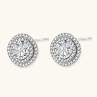 Angled view of round moissanite double halo stud earrings with sterling silver post backs | Olaty