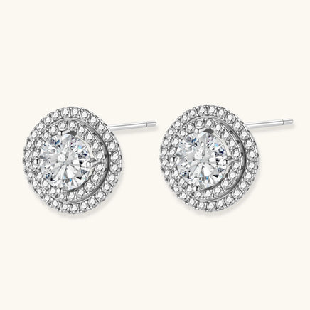 Angled view of round moissanite double halo stud earrings with sterling silver post backs | Olaty