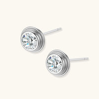 Angled view of GRA Certified Moissanite Diamond Orbit Stud Earrings with polished silver setting | Olaty