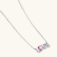 GRA certified pink moissanite LOVE necklace in sterling silver displayed at an angled product view | Olaty