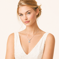 Woman wearing GRA certified blue moissanite diamond celestial arc necklace with sterling silver V-shaped setting | Olaty