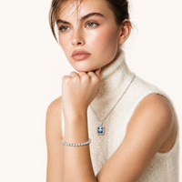 Model wearing Prism Dreams Necklace with brilliant rectangular moissanite pendant and sparkling halo setting | Olaty