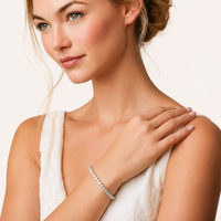 Classic moissanite tennis bracelet worn on wrist with elegant white outfit | Olaty