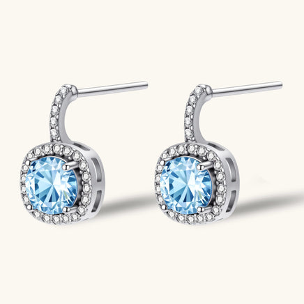 GRA certified blue moissanite diamond celestial halo drop earrings showing sterling silver post setting | Olaty