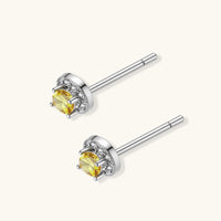 Angled back view of Yellow Moissanite Diamond Sunburst Halo Stud Earrings with sterling silver posts | Olaty