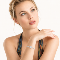 Model wearing Center Tennis Bracelet with square moissanite centerpiece and continuous sparkling sterling silver design | Olaty