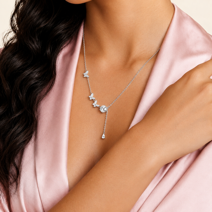 Woman wearing GRA certified moissanite diamond Flutter Dreams butterfly lariat necklace in sterling silver | Olaty