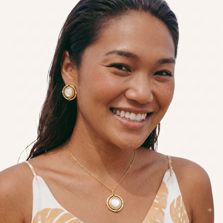 Model wearing cosmic mother of pearl orbital pendant necklace with matching round earrings | Olaty