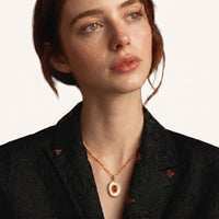 Model wearing oval amber cameo statement pendant necklace with mother-of-pearl surround | Olaty