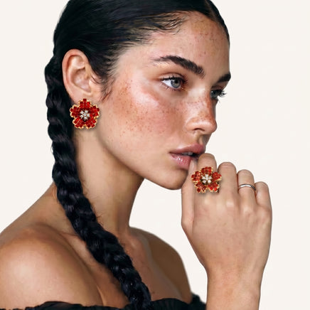 Model wearing crimson floral statement ring with matching red flower earrings | Olaty