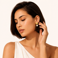 Model wearing Petal Drop Pearl Earrings with freshwater pearls and sculptural golden floral drops | Olaty